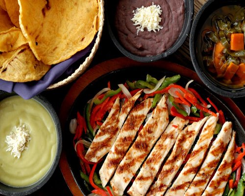 A well-balanced Mexican meal with beans, tortillas, and fresh vegetables