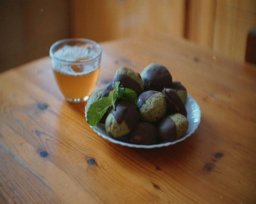 Fresh local fruits and a glass of plain water on a wooden table