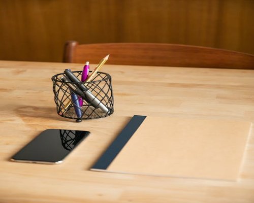 A notebook closed on a desk marking the end of the workday