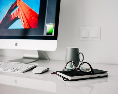 A person doing light stretches next to a home office desk